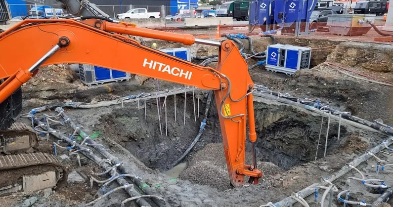 Hitachi digger digging hole